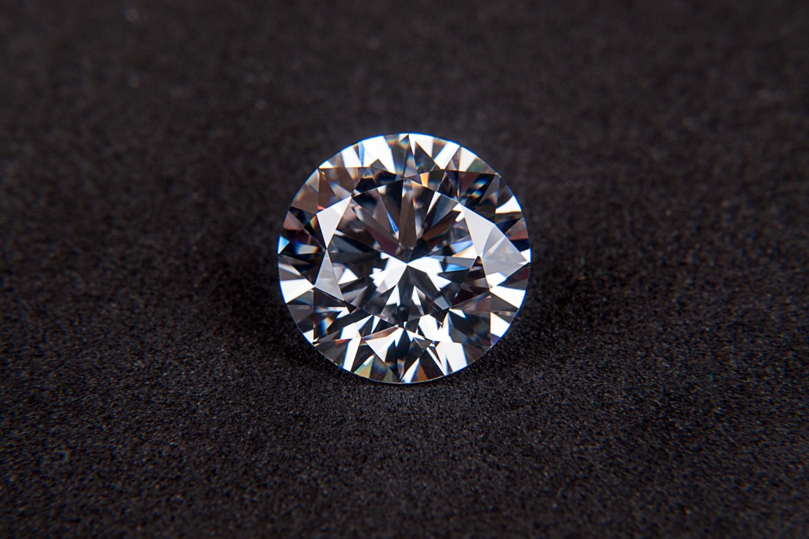 Loose round brilliant cut diamond on black velvet.