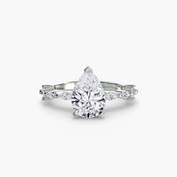 Solitaire with Eternity Pavé ring setting in 14k white gold with pear center stone